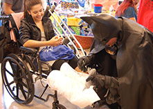 Photo of Batman signing a girl's cast. Link to Tangible Personal Property. tangible.jpg